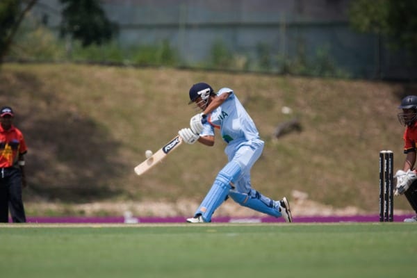 Batsman hitting cricket ball